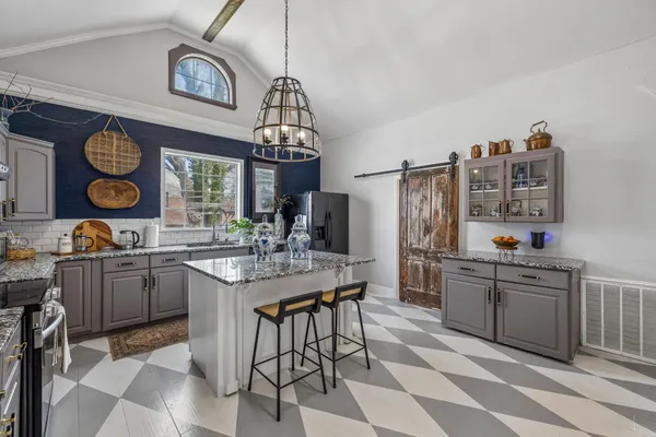 a kitchen with cabinets and window
