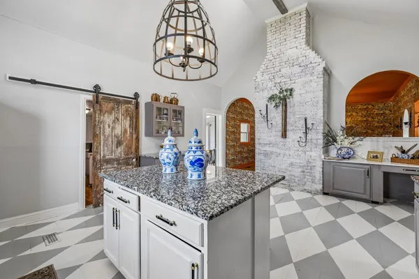 a kitchen with stainless steel appliances granite countertop a sink and cabinets