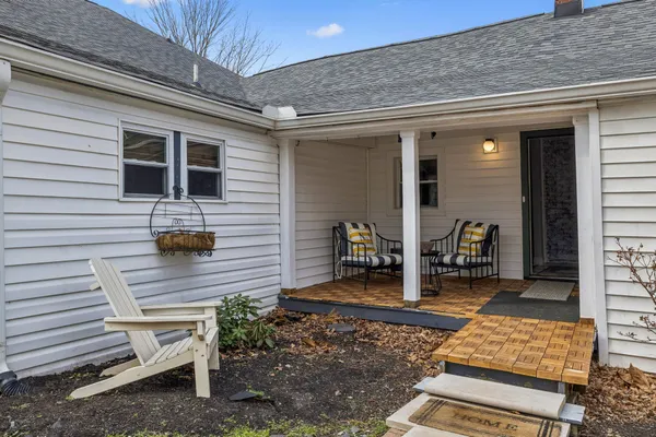 a backyard of a house with barbeque oven table and chairs
