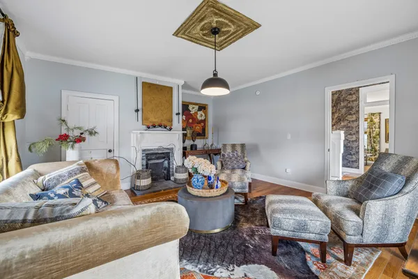 a living room with fireplace furniture and a wooden floor