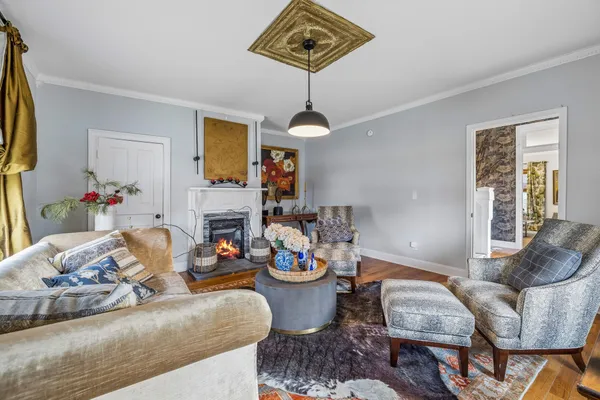 a living room with fireplace furniture and a wooden floor