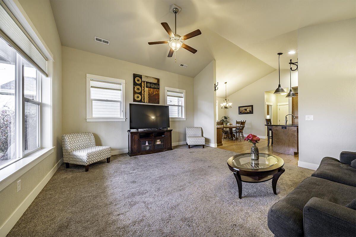 1078 North Haskell Street Central Point, OR 97502 - Photo 5 of 25 a living room with furniture a flat screen tv and a large window