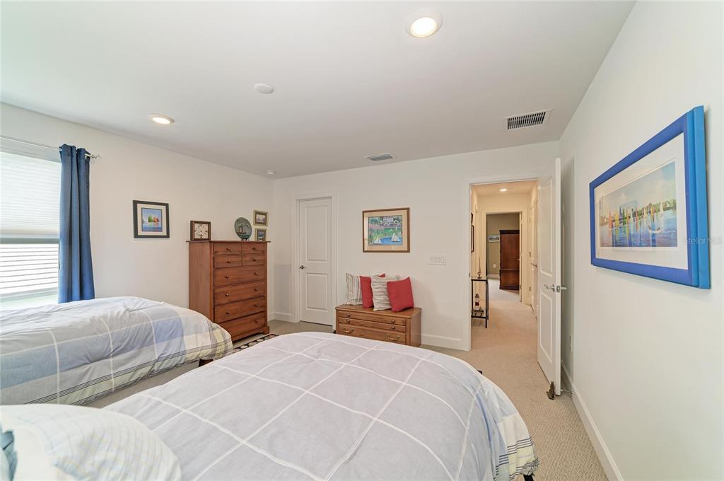 16341 Hidden Oak Loop Lakewood Ranch, FL 34211 - Photo 50 of 76 a bedroom with two beds and a large mirror