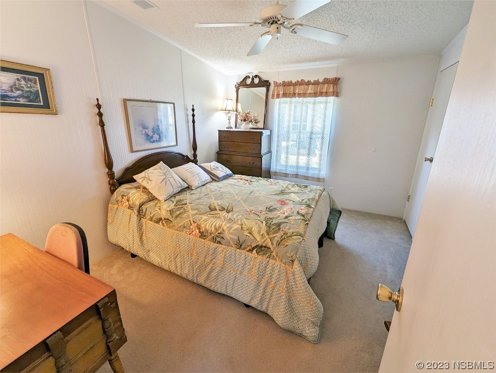 708 Navigators Way Edgewater, FL 32141 - Photo 11 of 26 a bedroom with a bed mirror and window