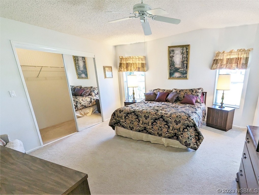 708 Navigators Way Edgewater, FL 32141 - Photo 12 of 26 a bedroom with a large bed and a window