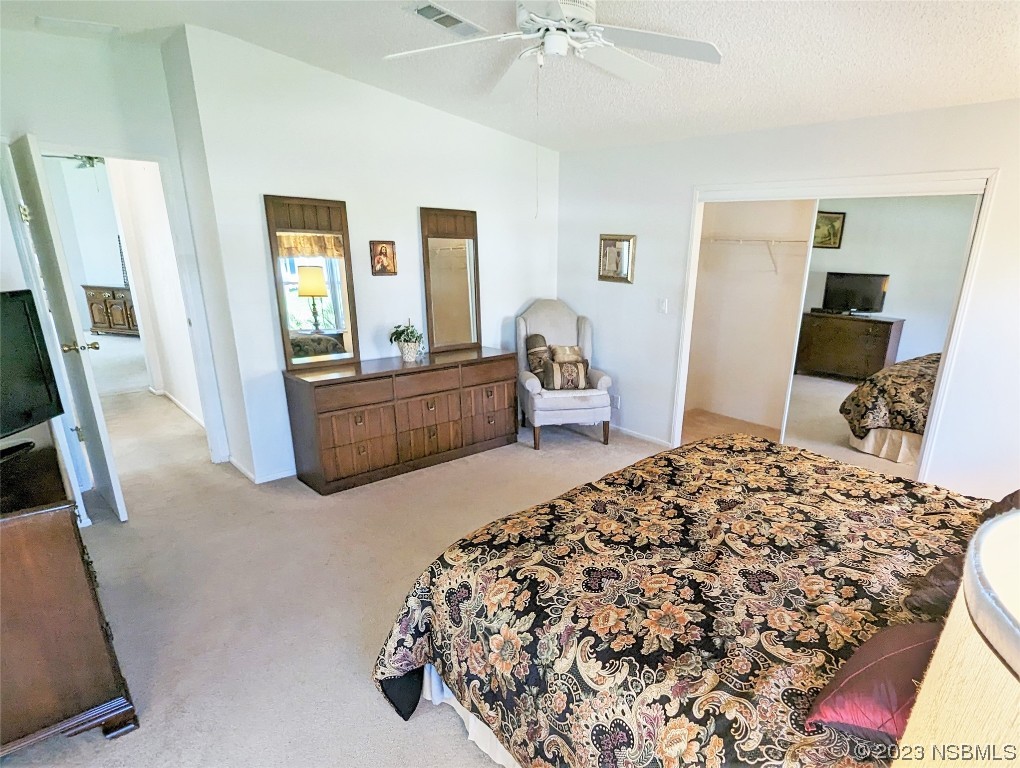 708 Navigators Way Edgewater, FL 32141 - Photo 13 of 26 a bedroom with a bed and wooden floor