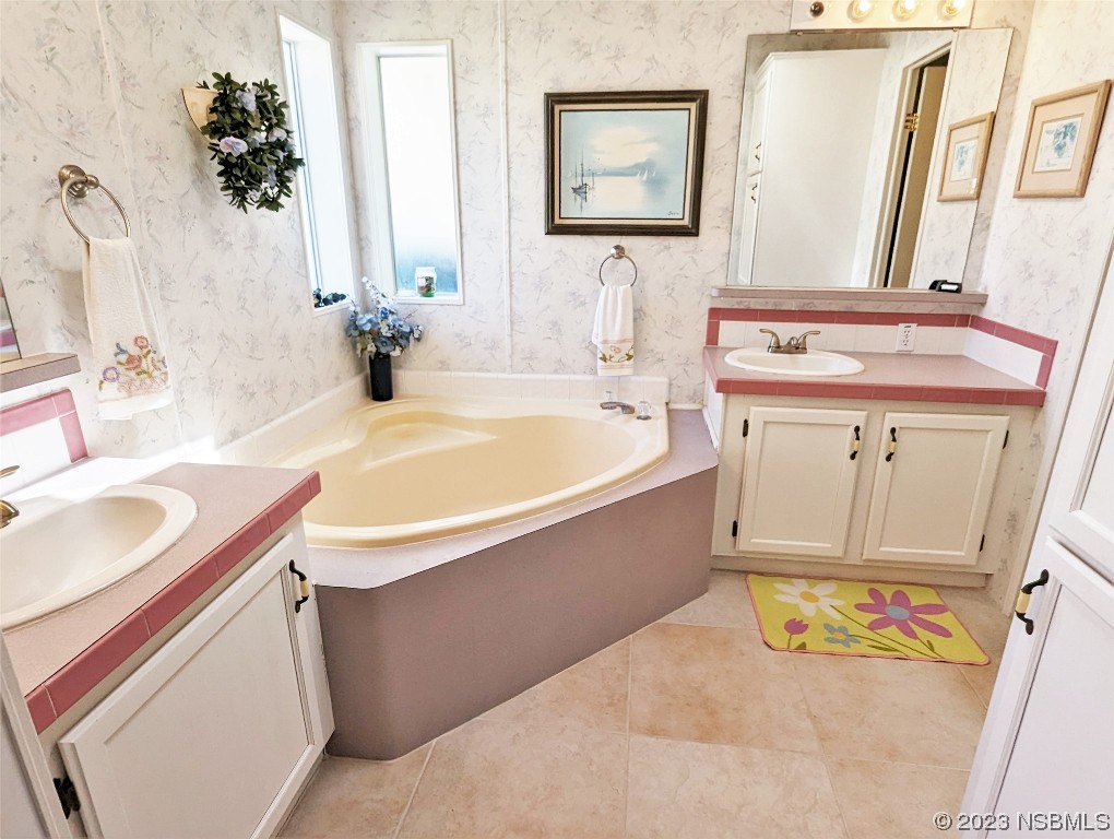 708 Navigators Way Edgewater, FL 32141 - Photo 14 of 26 a bathroom with a sink and a mirror