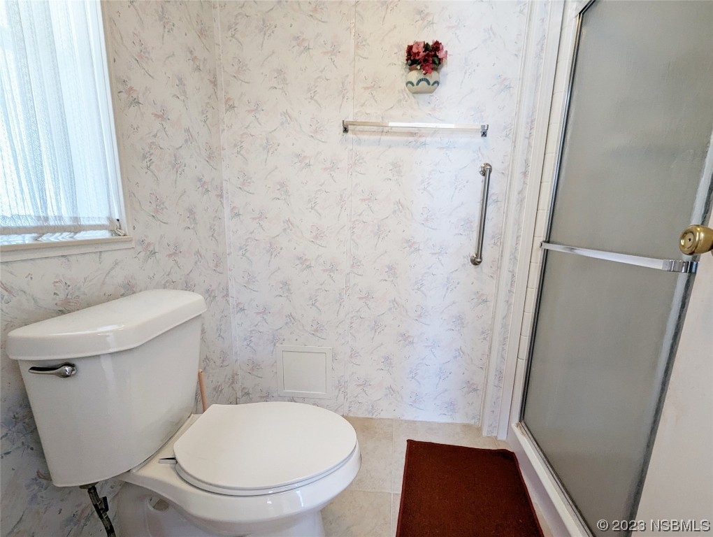 708 Navigators Way Edgewater, FL 32141 - Photo 15 of 26 a white toilet sitting next to a shower