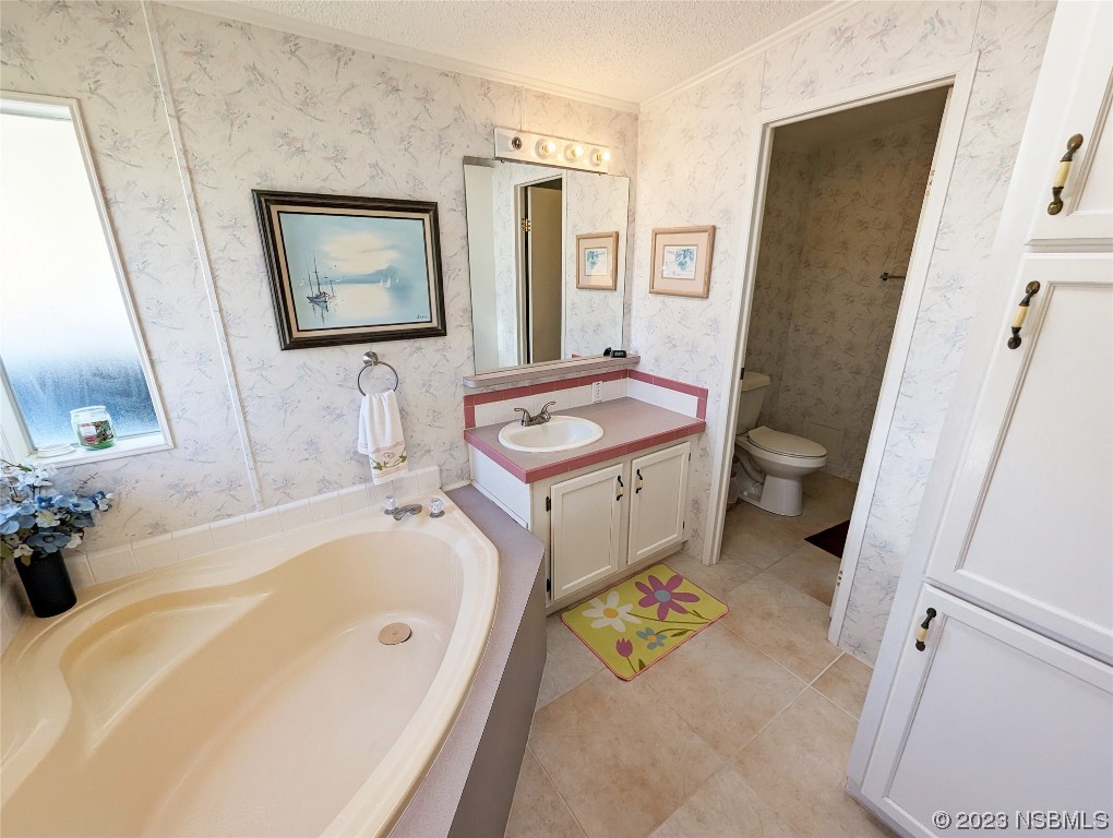 708 Navigators Way Edgewater, FL 32141 - Photo 16 of 26 a bathroom with a tub sink and mirror