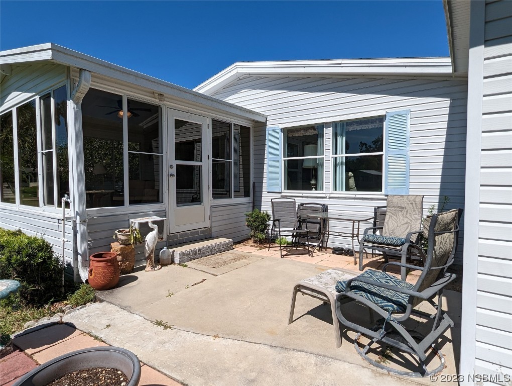 708 Navigators Way Edgewater, FL 32141 - Photo 20 of 26 a view of a house with chairs in patio