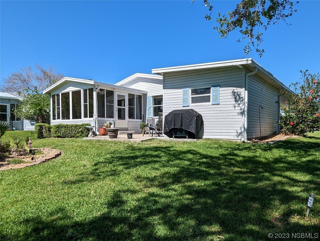 708 Navigators Way Edgewater, FL 32141 - Photo 22 of 26 a front view of house with yard and green space