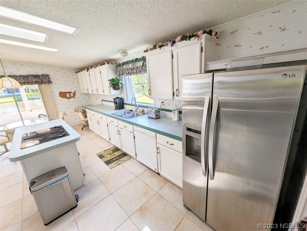 708 Navigators Way Edgewater, FL 32141 - Photo 7 of 26 a kitchen with a sink stove and refrigerator