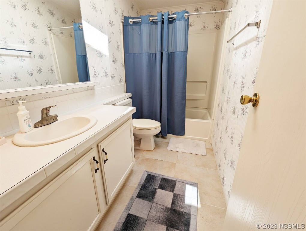 708 Navigators Way Edgewater, FL 32141 - Photo 10 of 26 a bathroom with a sink a toilet and shower
