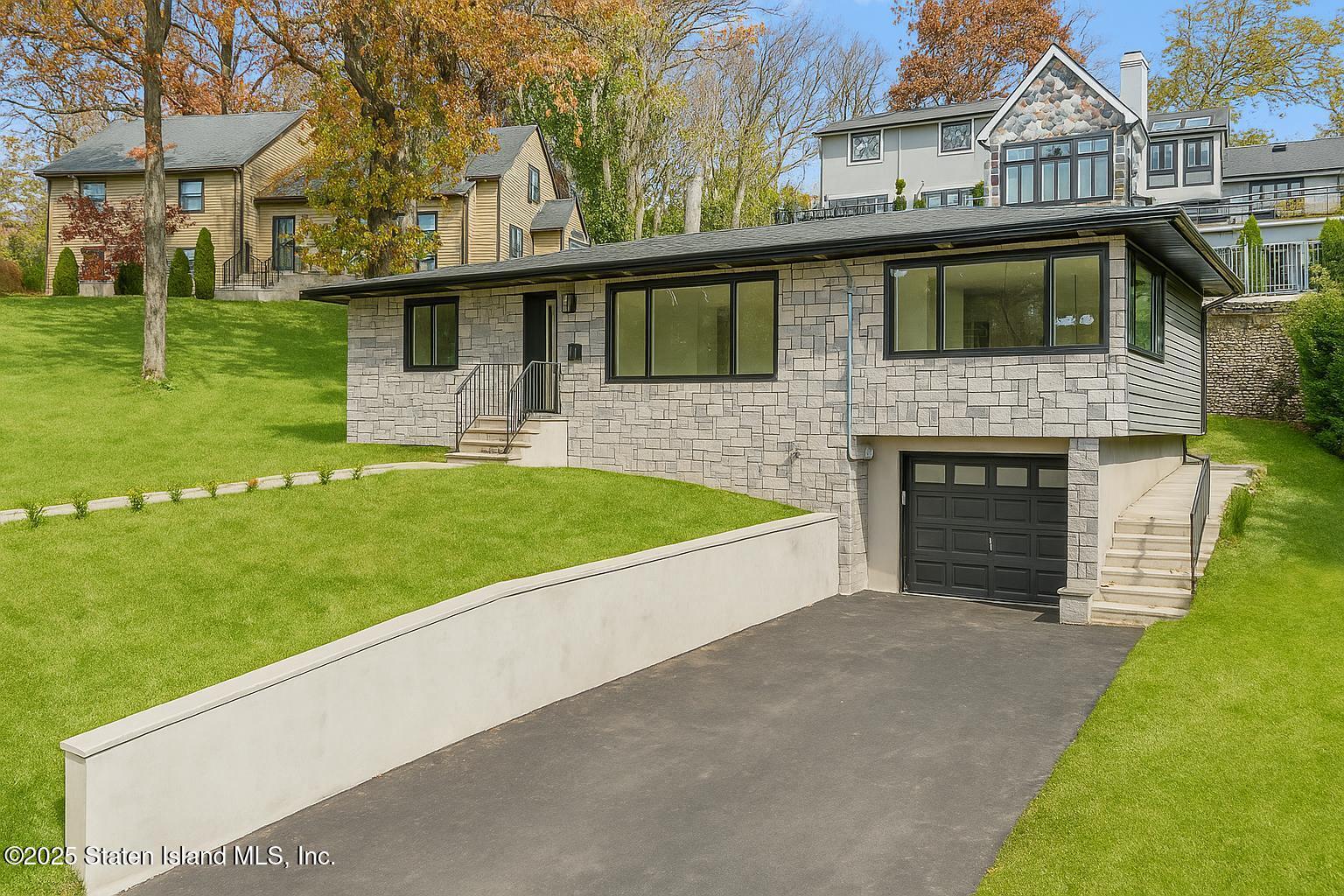 a front view of a house with a garden