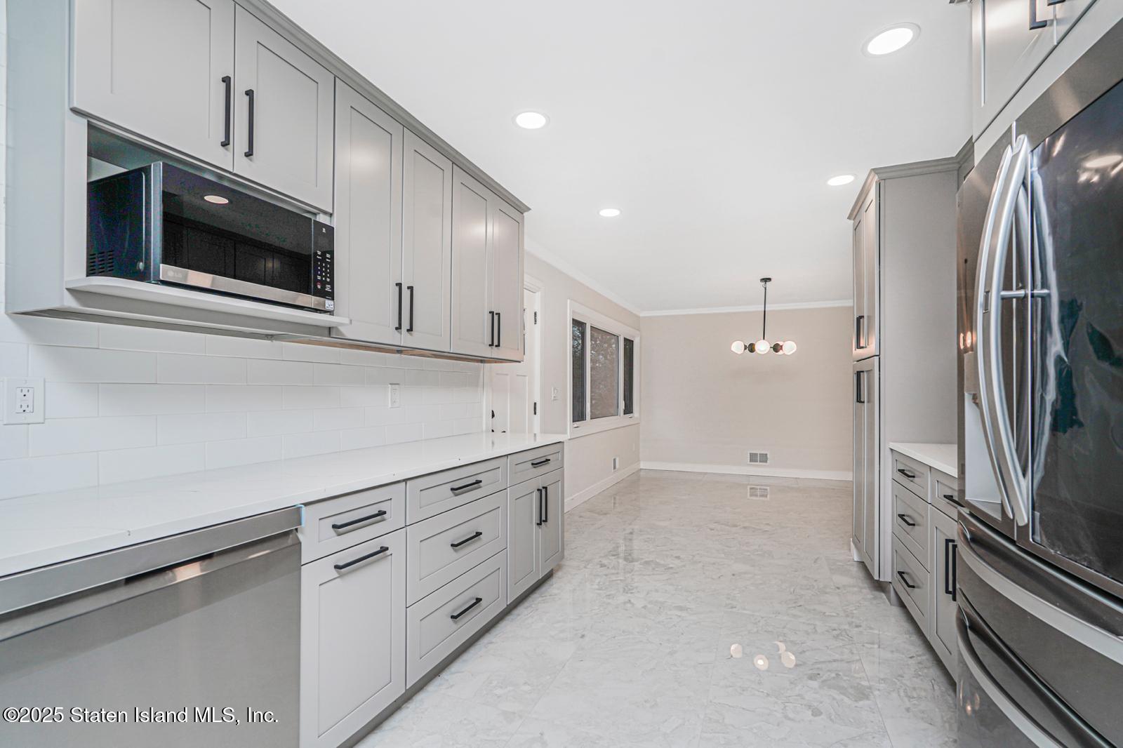 113 Longview Road Staten Island, NY 10304 - Photo 13 of 35 a kitchen with stainless steel appliances cabinets and a kitchen counter top