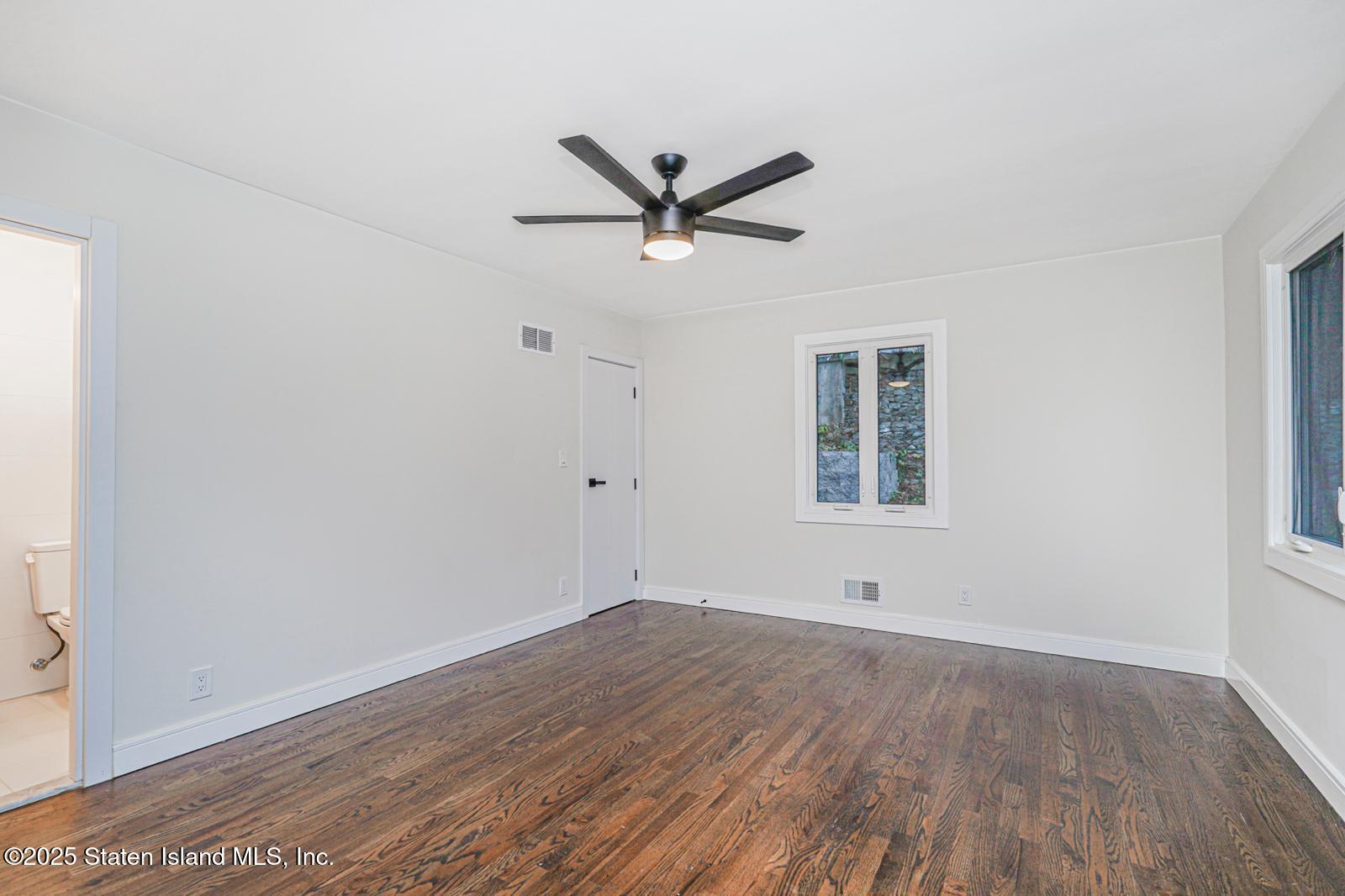 113 Longview Road Staten Island, NY 10304 - Photo 27 of 35 an empty room with wooden floor and windows