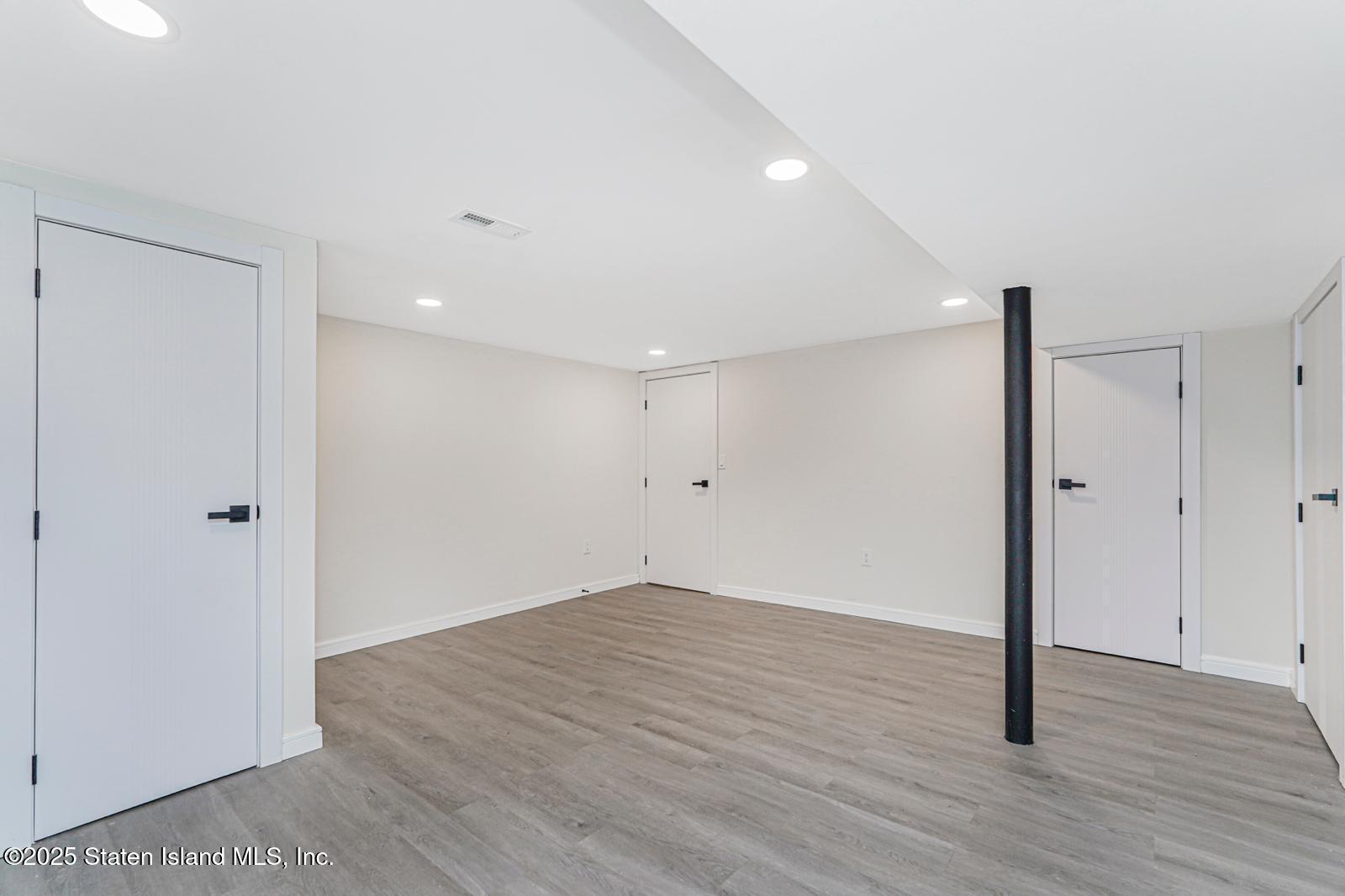 113 Longview Road Staten Island, NY 10304 - Photo 31 of 35 a view of an empty room with wooden floor