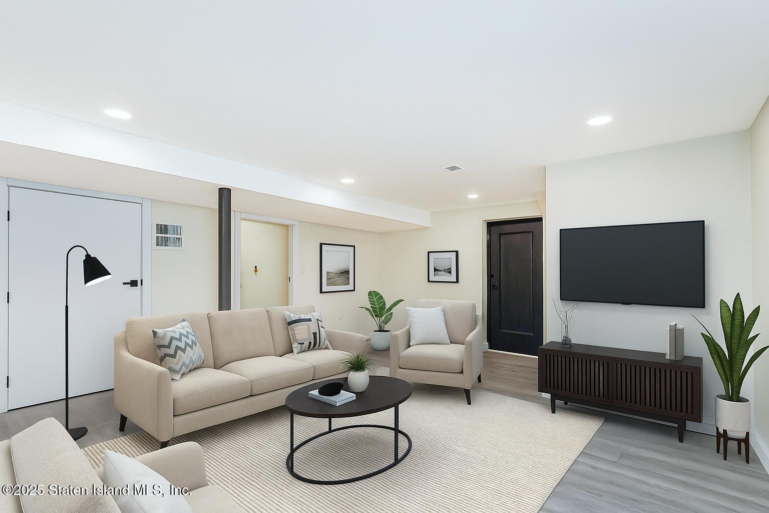 113 Longview Road Staten Island, NY 10304 - Photo 6 of 35 a living room with furniture and a flat screen tv