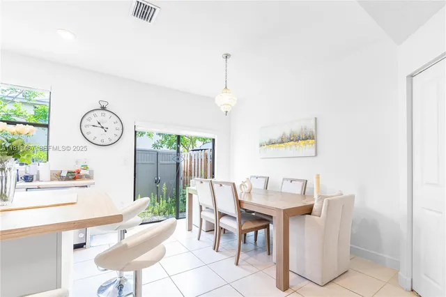 a dining room with furniture a window and a clock