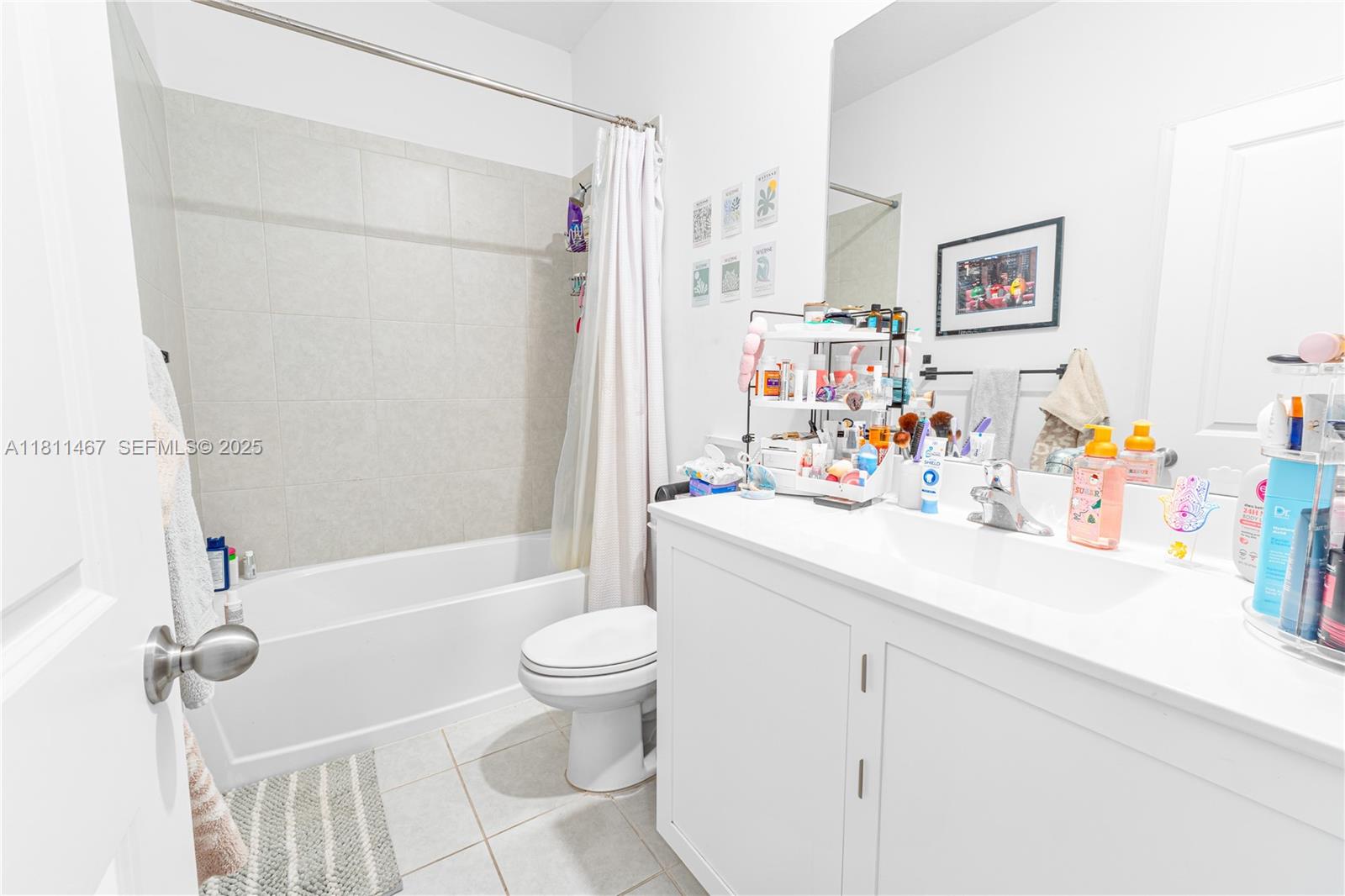 817 Northeast 211th Street Miami, FL 33179 - Photo 13 of 20 a bathroom with a sink a toilet and shower