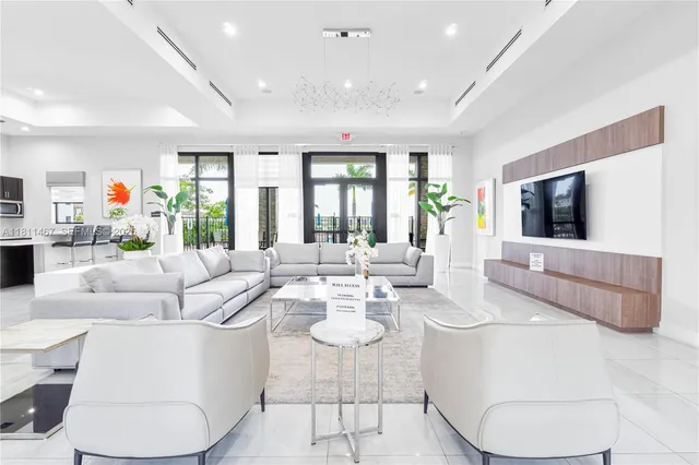 a living room with furniture a flat screen tv and a large window