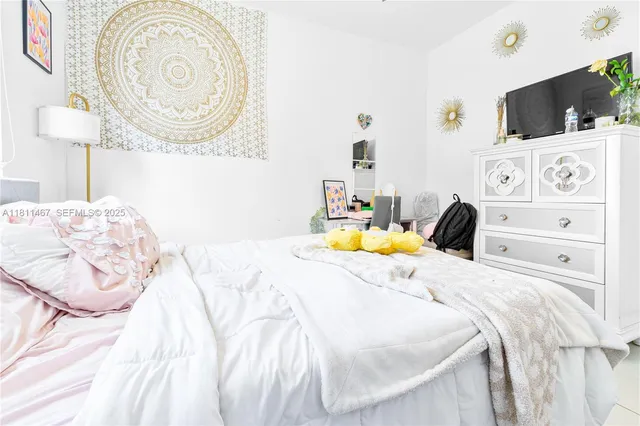 a bedroom with a bed and a television