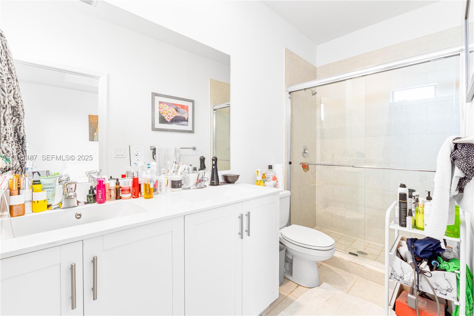 817 Northeast 211th Street Miami, FL 33179 - Photo 7 of 20 a bathroom with a sink a toilet and a shower