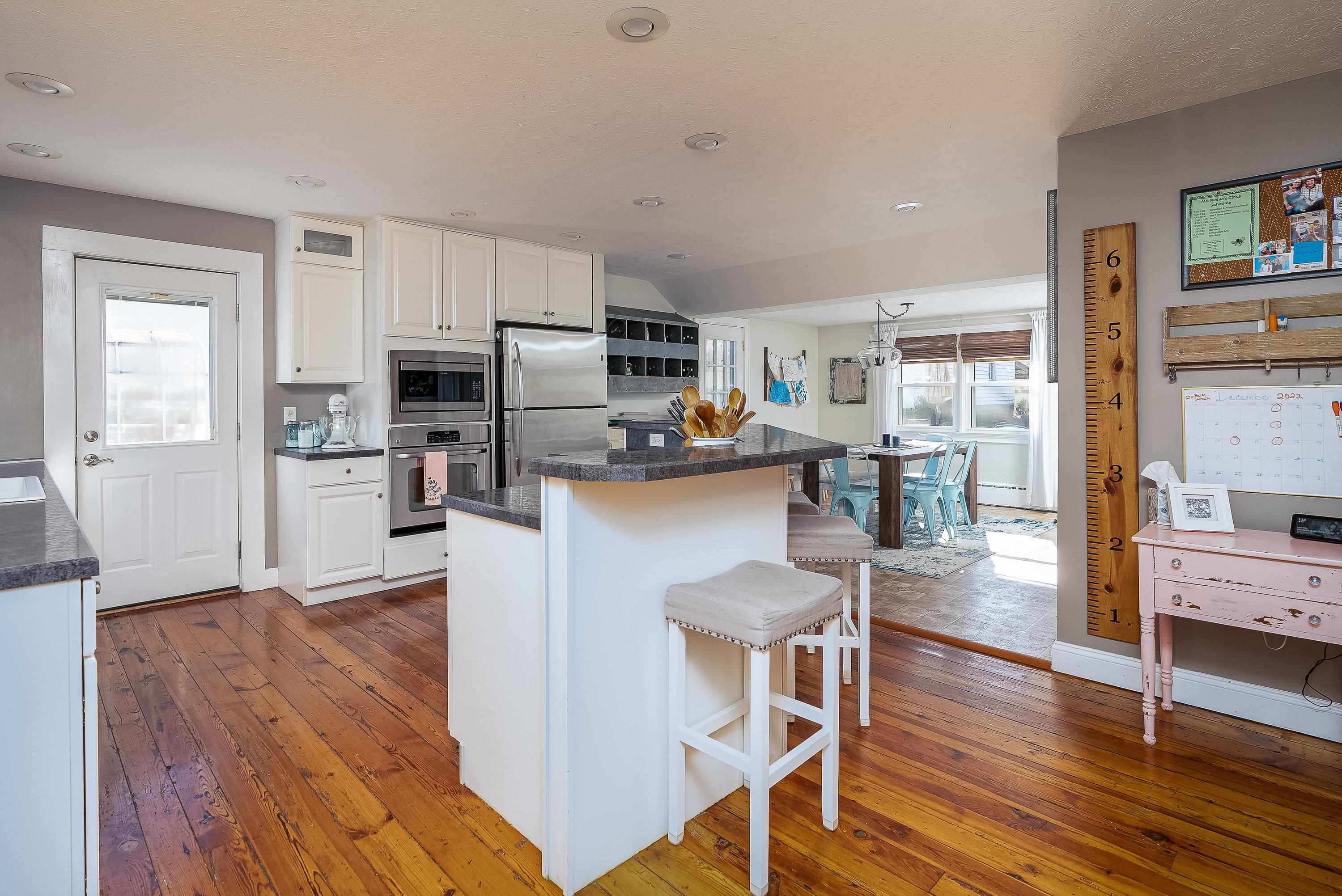 3667 Dry Hollow Road Dayton, VA 22821 - Photo 13 of 68 a living room with stainless steel appliances a dining table wooden floor and a kitchen view