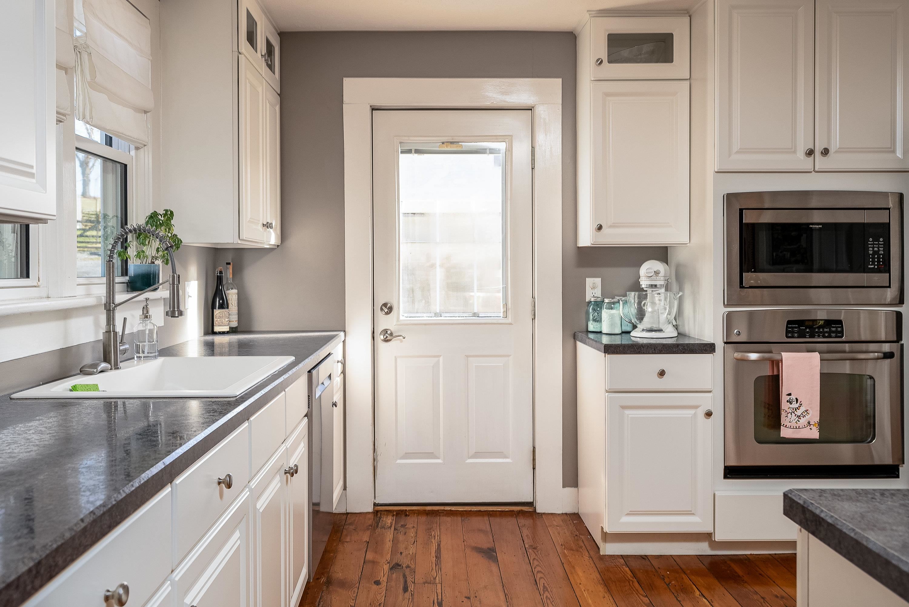 3667 Dry Hollow Road Dayton, VA 22821 - Photo 14 of 68 a kitchen with stainless steel appliances granite countertop a refrigerator a stove and white cabinets with wooden floor