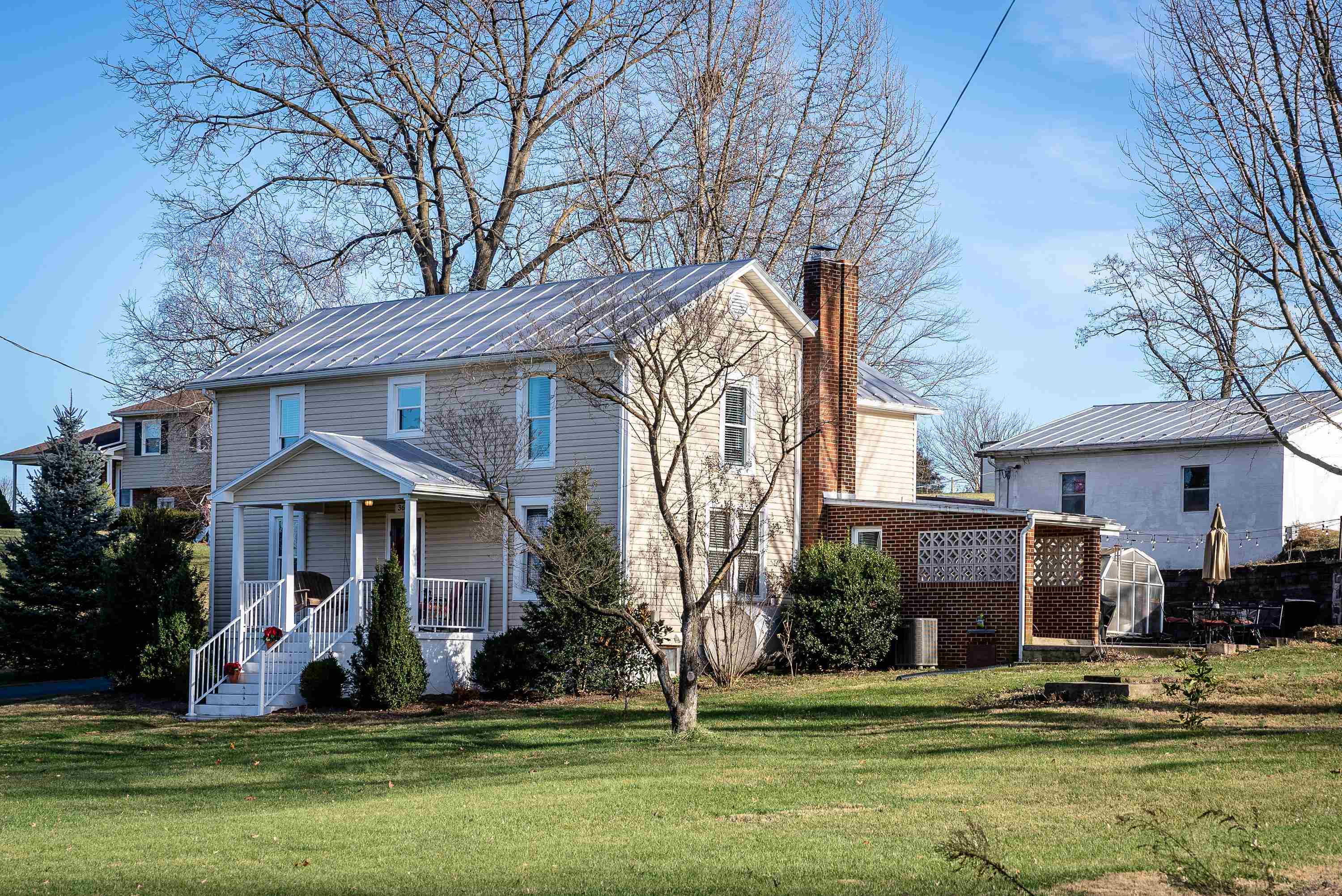 3667 Dry Hollow Road Dayton, VA 22821 - Photo 3 of 68 a front view of a house with a garden and trees
