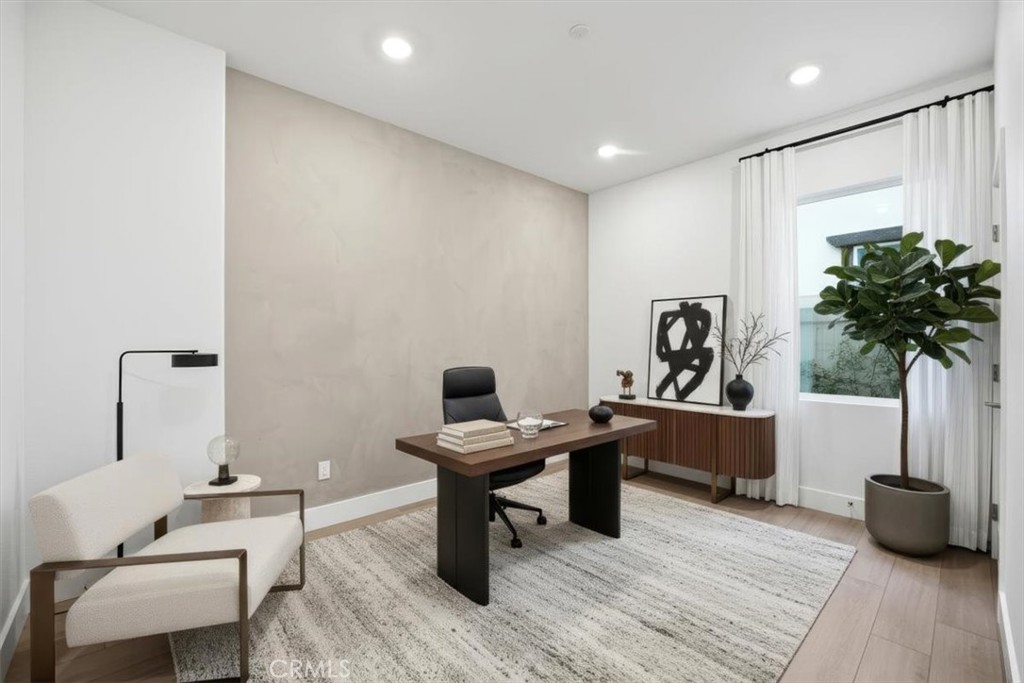437 Willow Run Lane Carson, CA 90745 - Photo 12 of 37 a view of a workspace with furniture and a potted plant