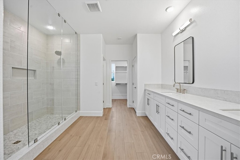 437 Willow Run Lane Carson, CA 90745 - Photo 18 of 37 a bathroom with a double vanity sink and mirror