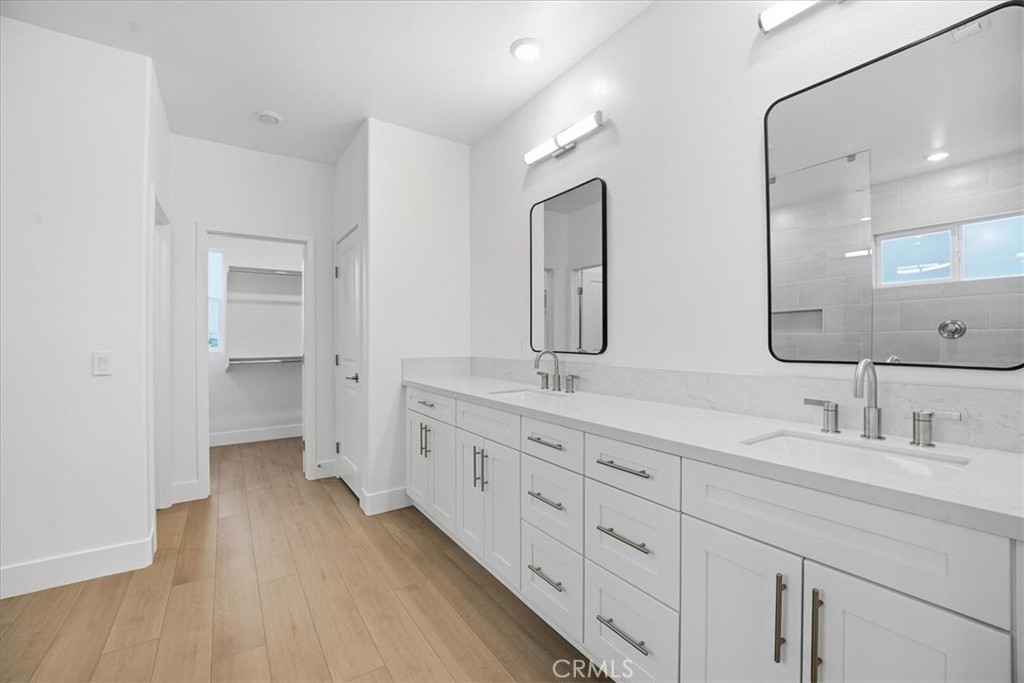 437 Willow Run Lane Carson, CA 90745 - Photo 19 of 37 a bathroom with a double vanity sink and mirror