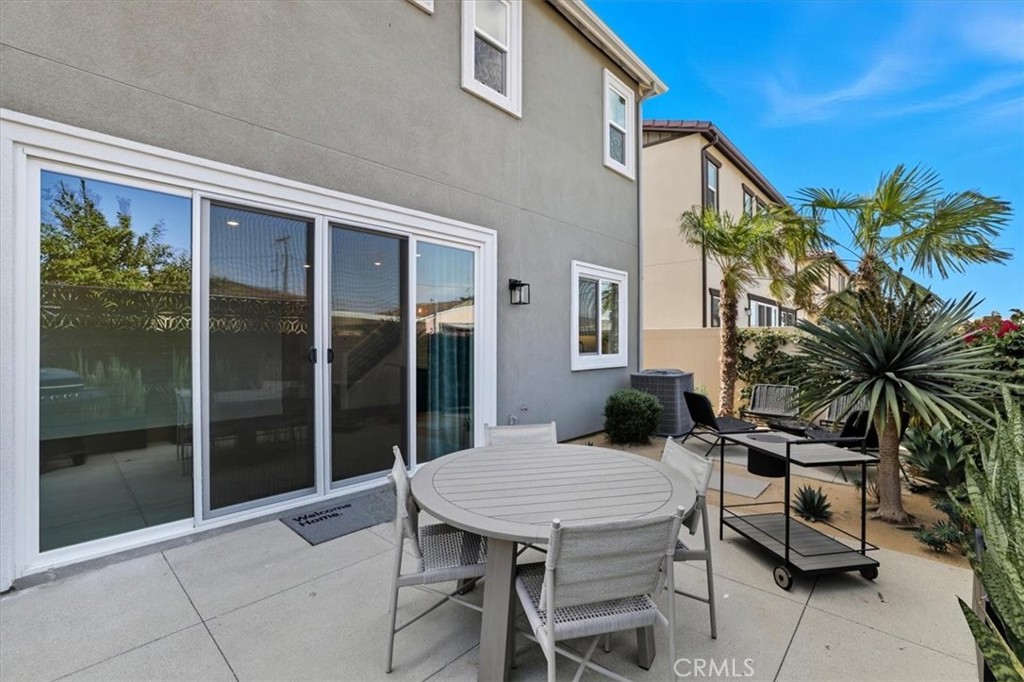 437 Willow Run Lane Carson, CA 90745 - Photo 26 of 37 a view of a patio with a table and chairs and potted plants