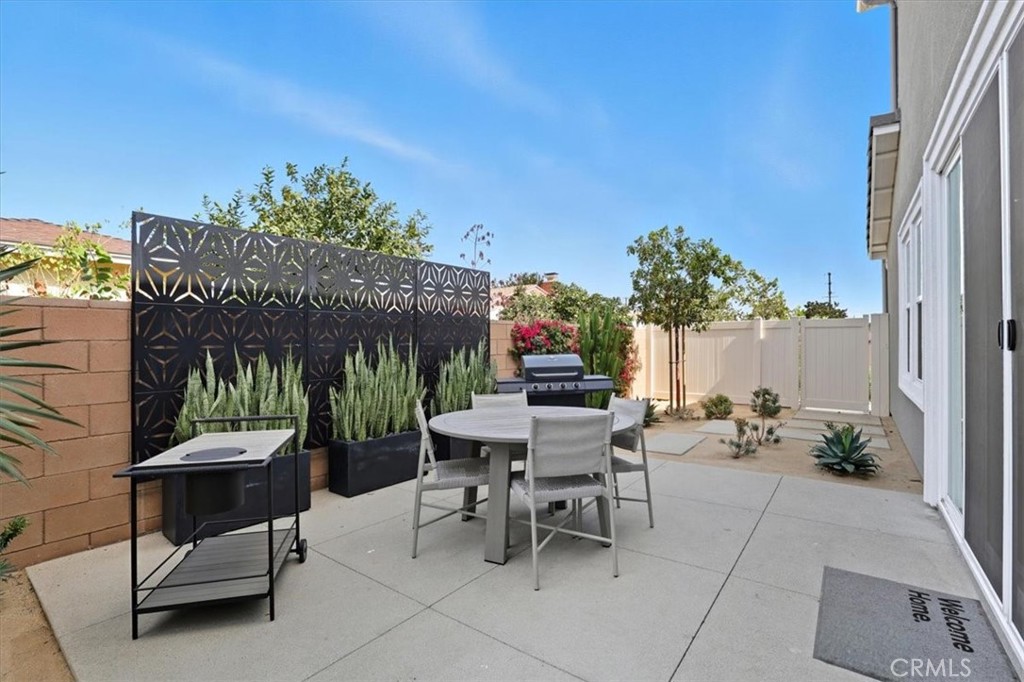 437 Willow Run Lane Carson, CA 90745 - Photo 28 of 37 a view of a patio with a table and chairs and potted plants