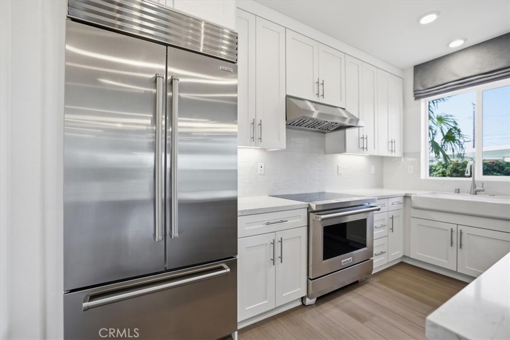437 Willow Run Lane Carson, CA 90745 - Photo 8 of 37 a kitchen with stainless steel appliances granite countertop a refrigerator and a stove top oven