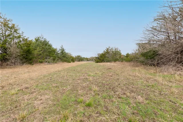 an aerial view of house with yard and mountain in the background