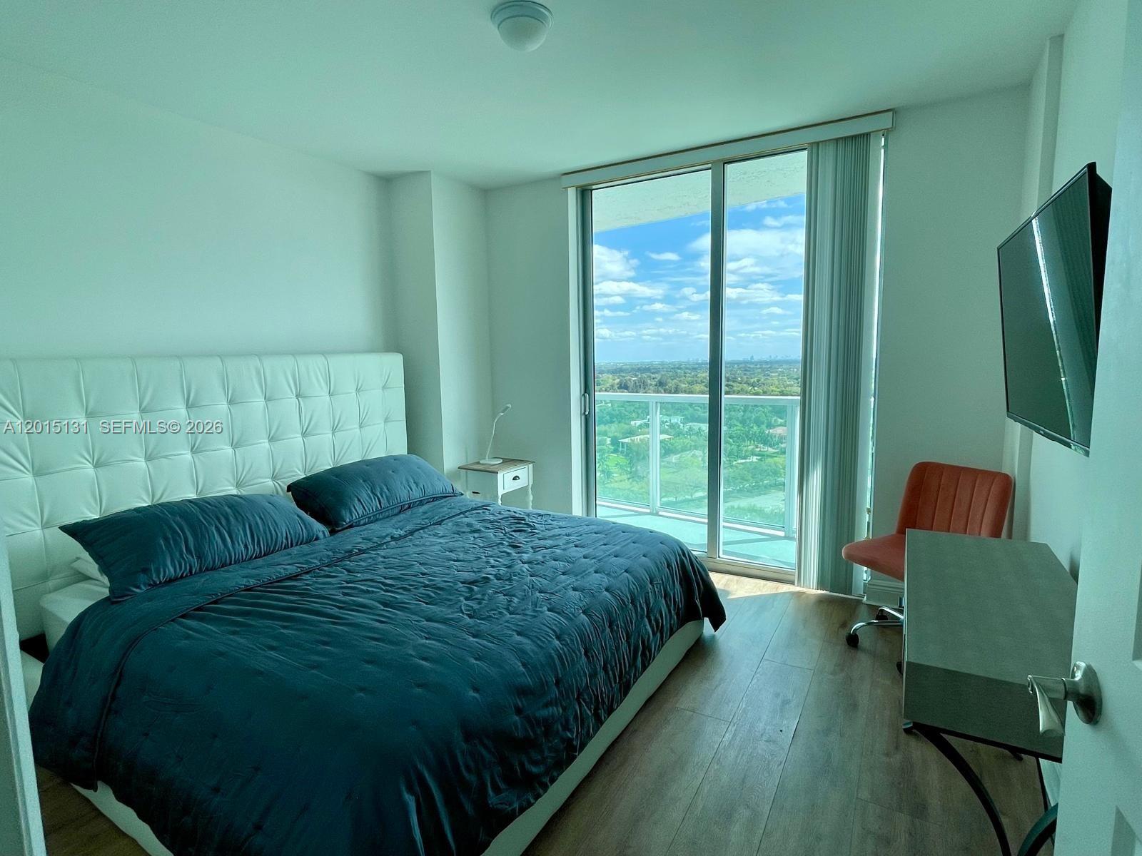 2681 North Flamingo Road, Unit 2004S Sunrise, FL 33323 - Photo 13 of 26 a bedroom with a bed window and mirror