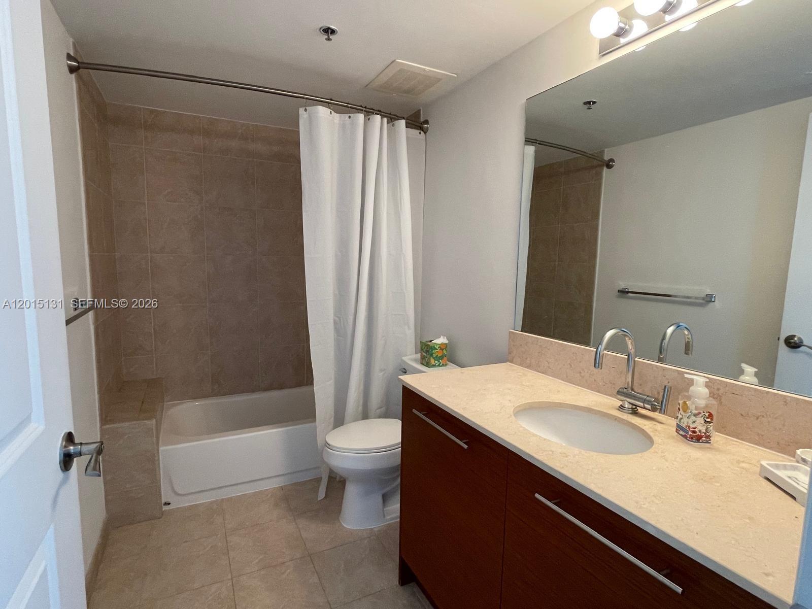 2681 North Flamingo Road, Unit 2004S Sunrise, FL 33323 - Photo 14 of 26 a bathroom with a granite countertop sink toilet and shower