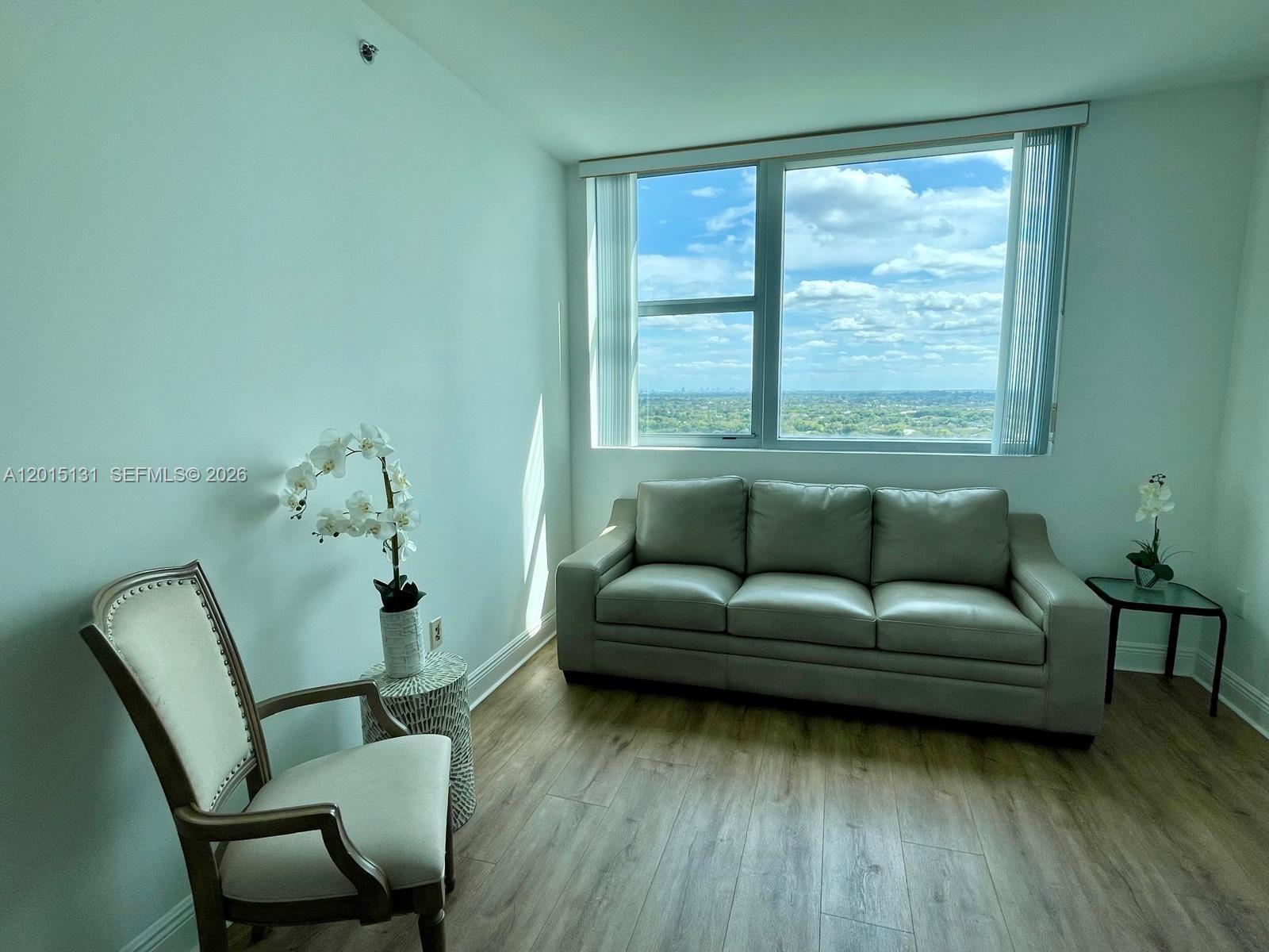 2681 North Flamingo Road, Unit 2004S Sunrise, FL 33323 - Photo 16 of 26 a living room with furniture and a wooden floor