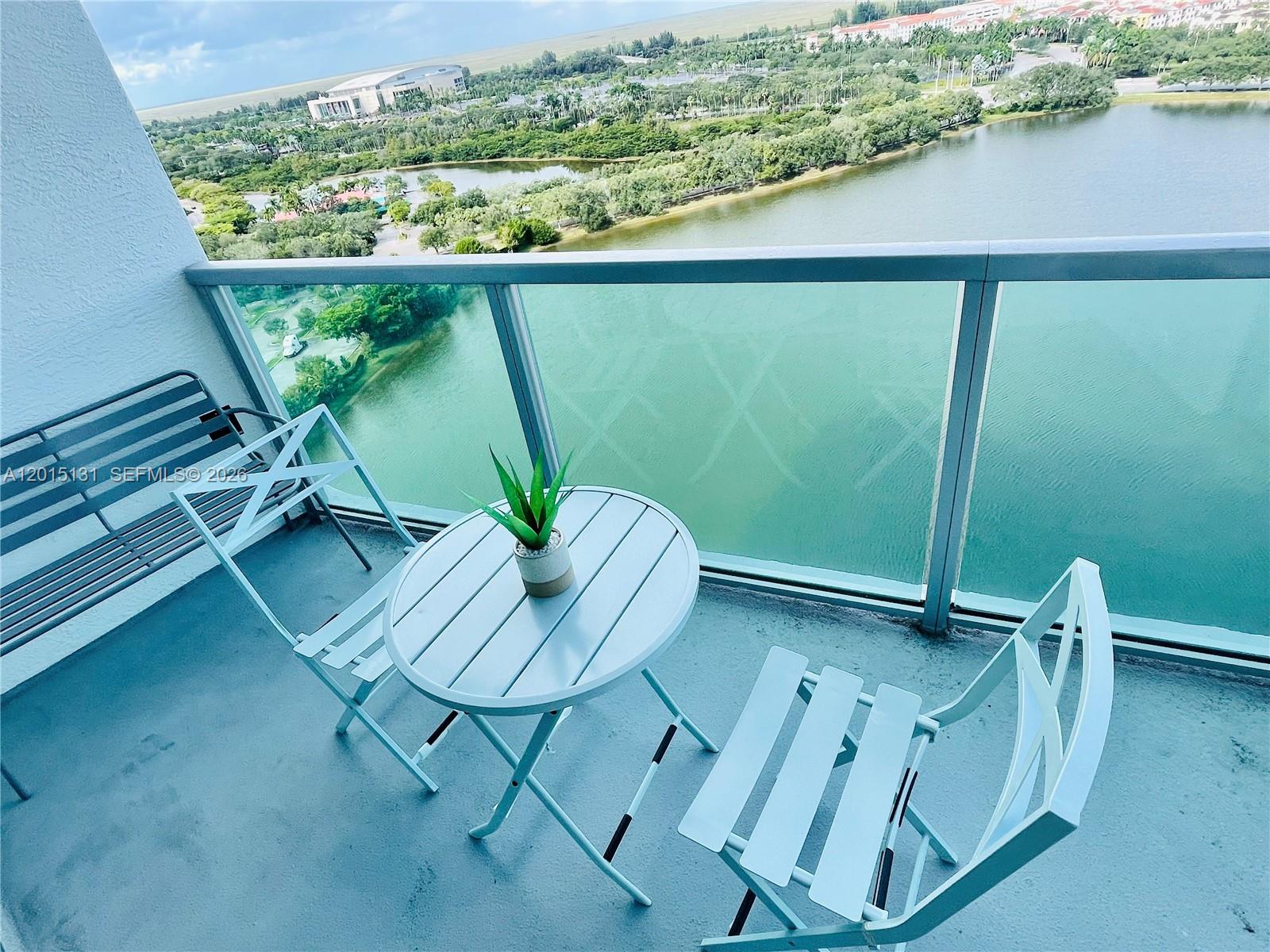 2681 North Flamingo Road, Unit 2004S Sunrise, FL 33323 - Photo 2 of 26 a balcony with table and chairs