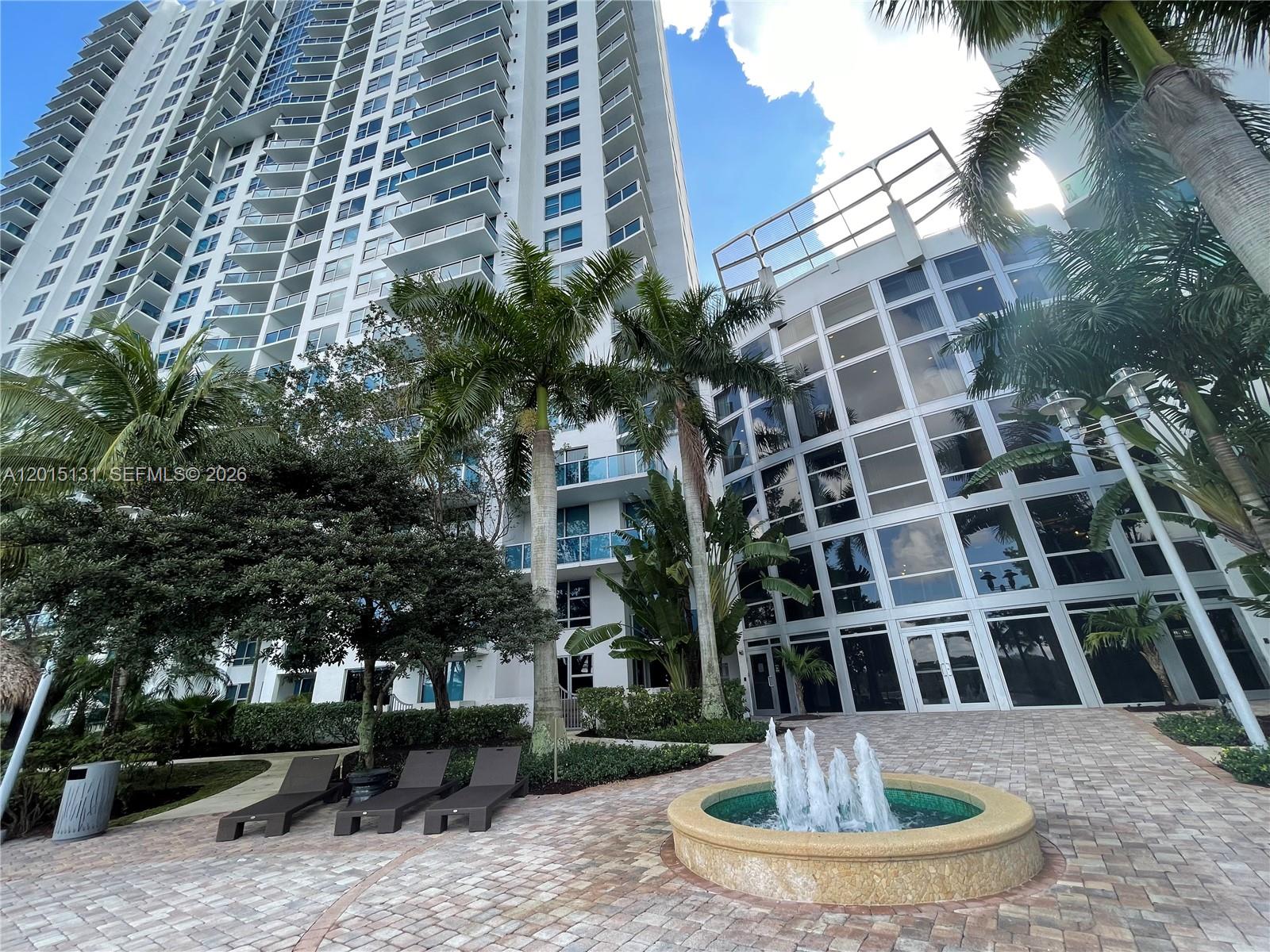 2681 North Flamingo Road, Unit 2004S Sunrise, FL 33323 - Photo 21 of 26 a view of a building with a fountain in front of a house