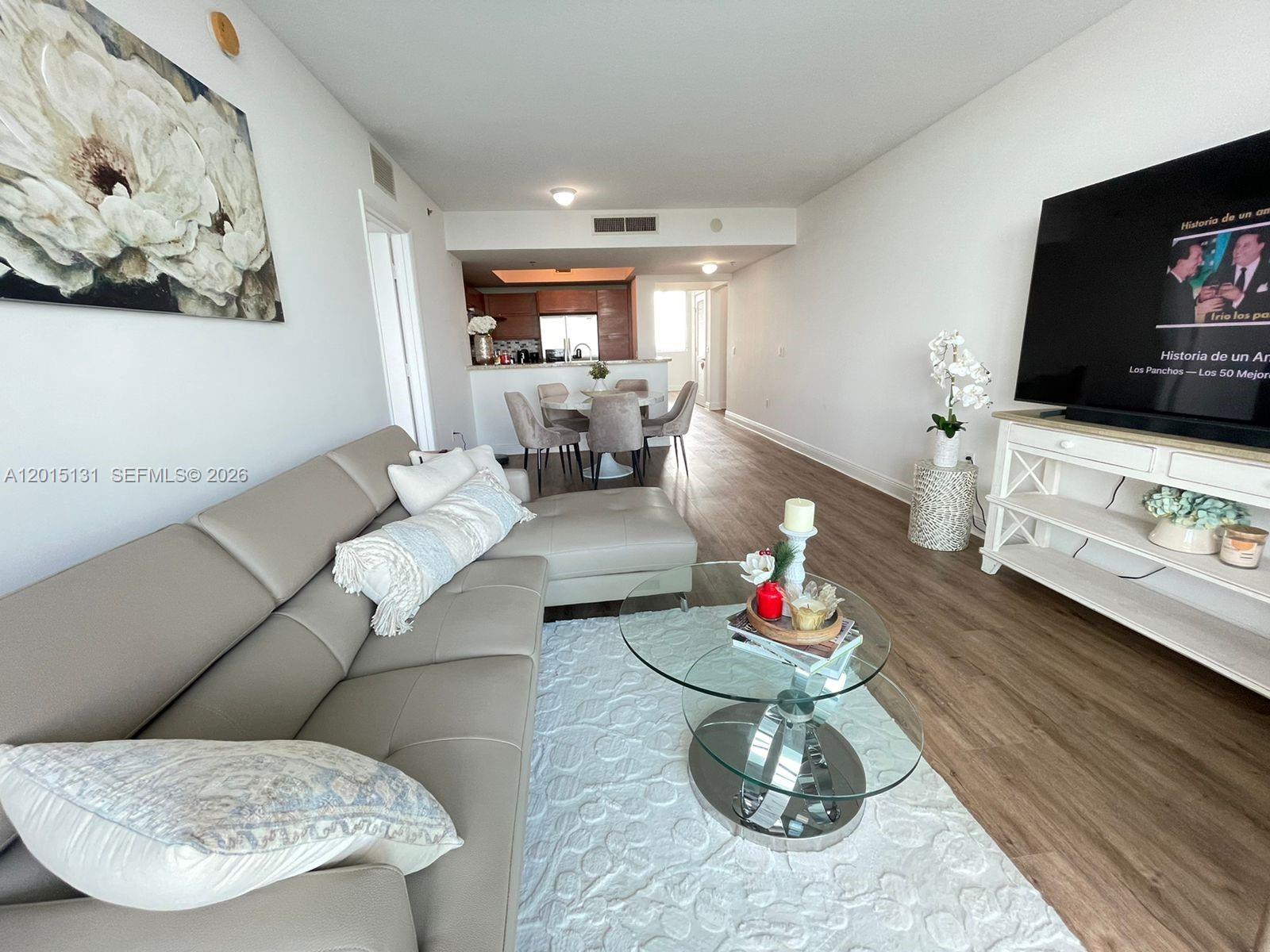 2681 North Flamingo Road, Unit 2004S Sunrise, FL 33323 - Photo 7 of 26 a living room with furniture and a flat screen tv