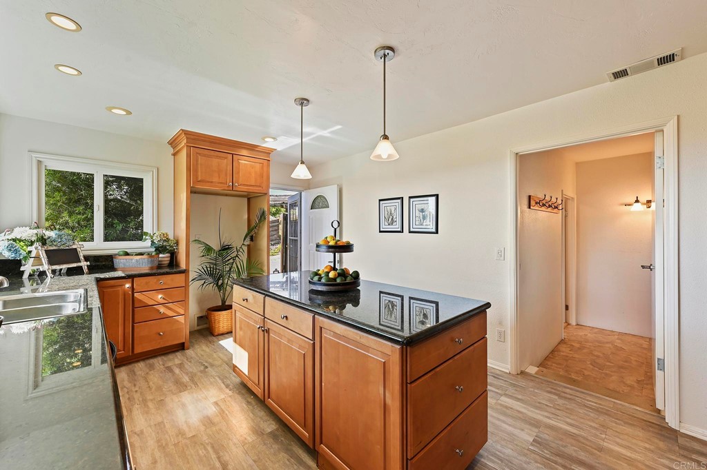 837 Passiflora Avenue Encinitas, CA 92024 - Photo 18 of 42 a kitchen with stainless steel appliances granite countertop a sink stove and refrigerator