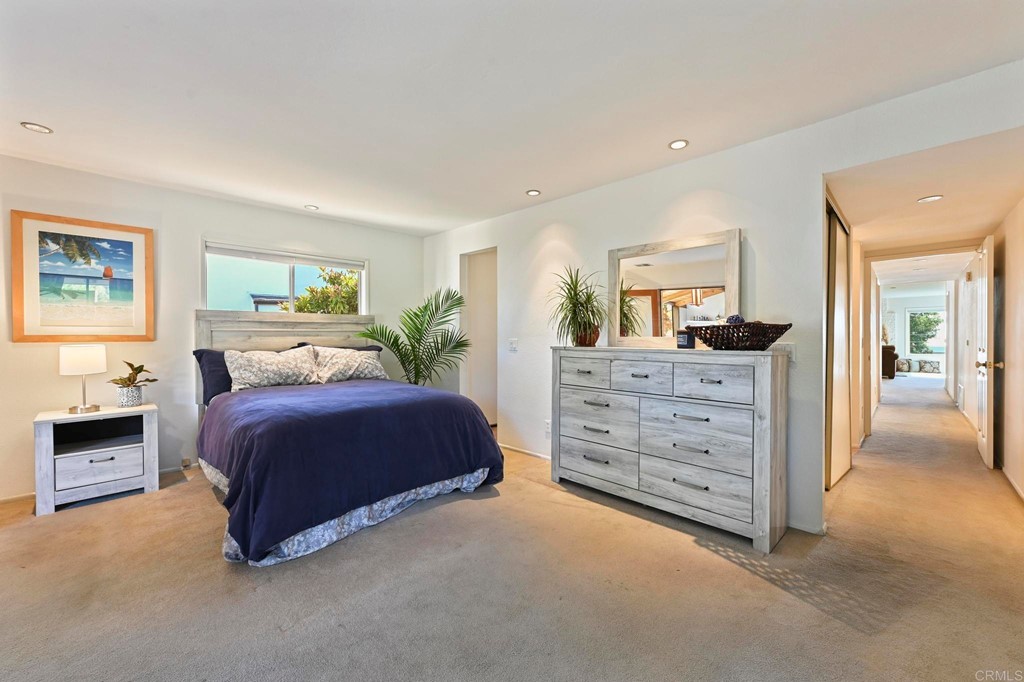 837 Passiflora Avenue Encinitas, CA 92024 - Photo 21 of 42 a spacious bedroom with a bed and a cabinets