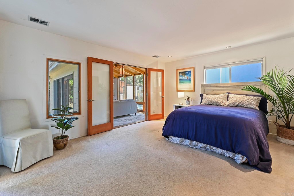 837 Passiflora Avenue Encinitas, CA 92024 - Photo 22 of 42 a spacious bedroom with a bed and a couch