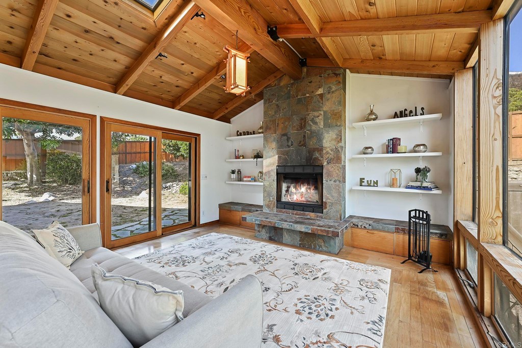 837 Passiflora Avenue Encinitas, CA 92024 - Photo 24 of 42 a living room with furniture fireplace and flat screen tv