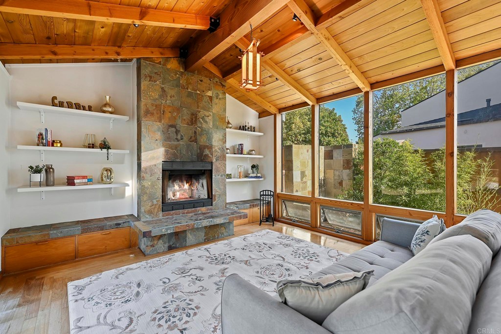 837 Passiflora Avenue Encinitas, CA 92024 - Photo 27 of 42 a living room with furniture a fireplace and a table