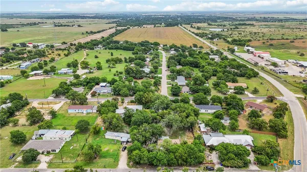 an aerial view of residential houses with outdoor space and river