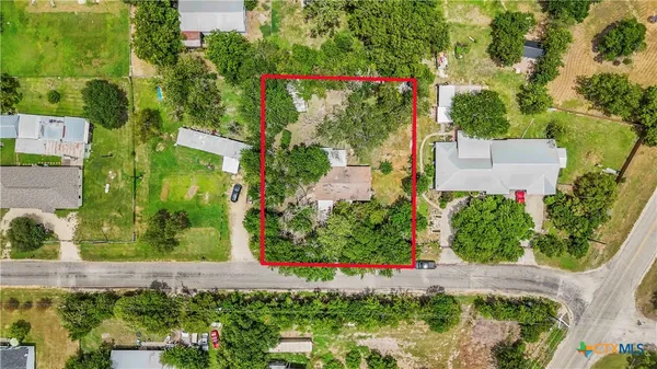 an aerial view of a house with a yard and garden